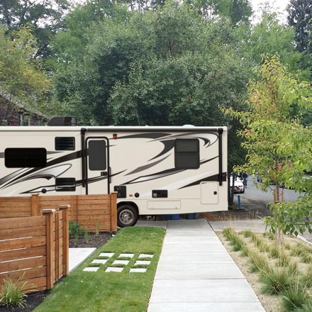 RV in driveway sticking out over sidewalk