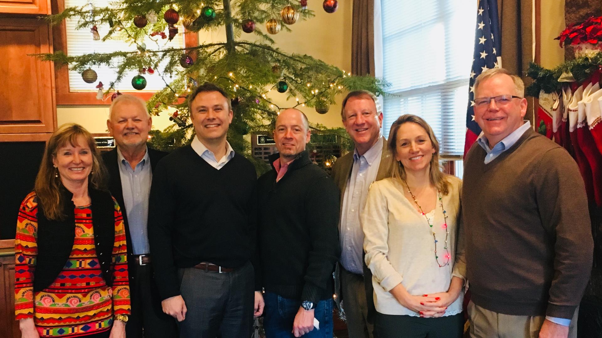 Eric King and the executive team standing in front of a Christmas tree. Merry Christmas!