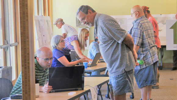 Community members learning about the Map Alignment Process at an open house.