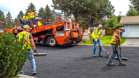 Streets crew applying a chipseal treatment to Bear Creek Rd.