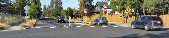 A man crossing the street ina crosswalk