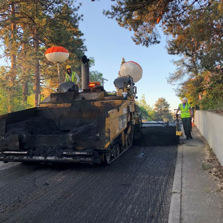 Streets crew resurfacing a road.