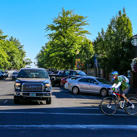 Cars and bicyclist on Wall Street in downtown.