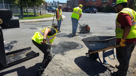 Streets crew fixing potholes.