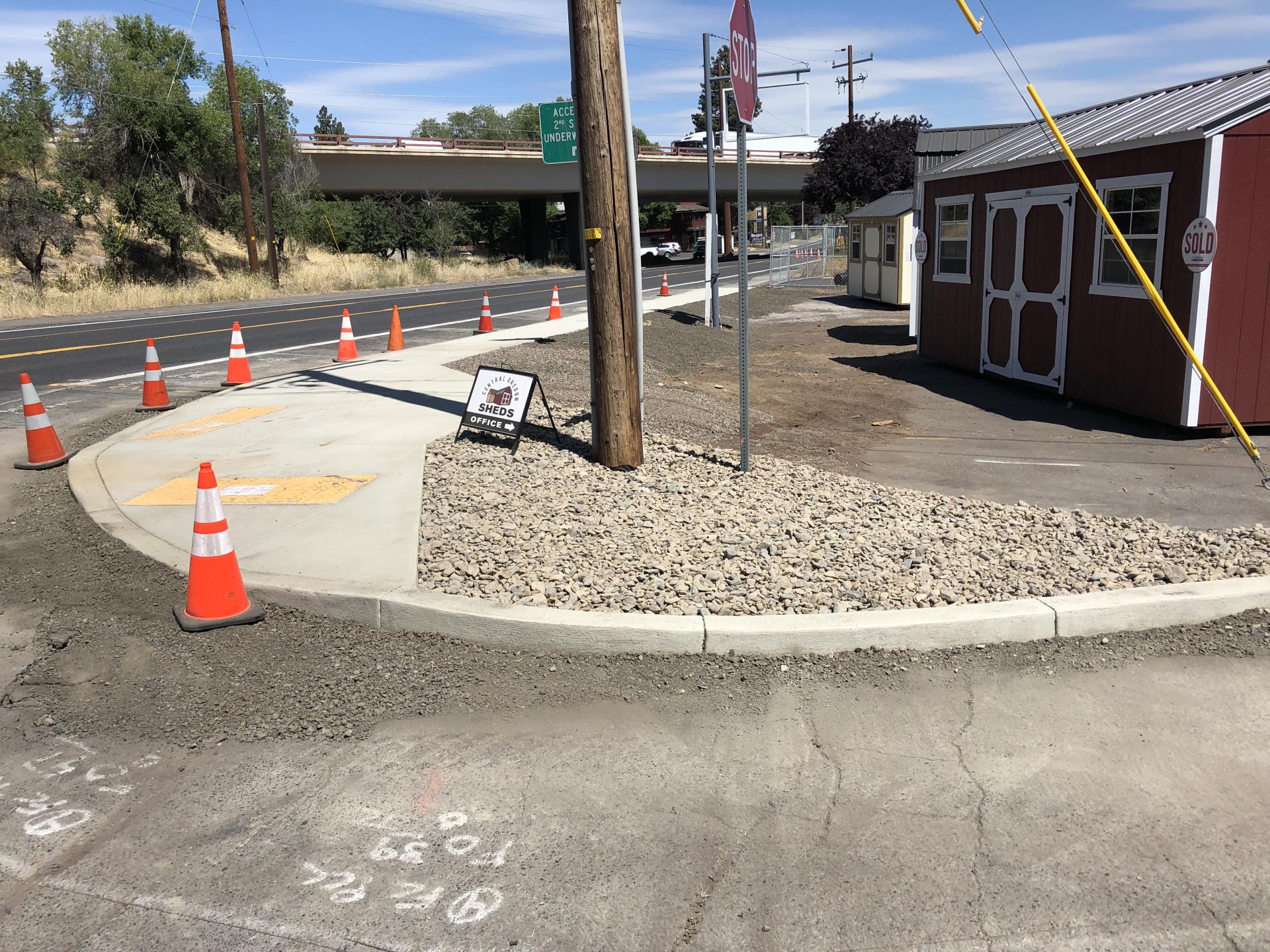 Division Street Photo 2 After – newly constructed curb ramps, curb extension, and sidewalk providing access around signs and utility poles.