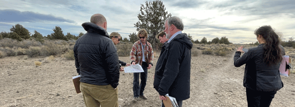 Group of people standing at the Stevens Road Tract.