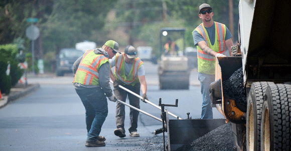 Construction crew paving a roadway