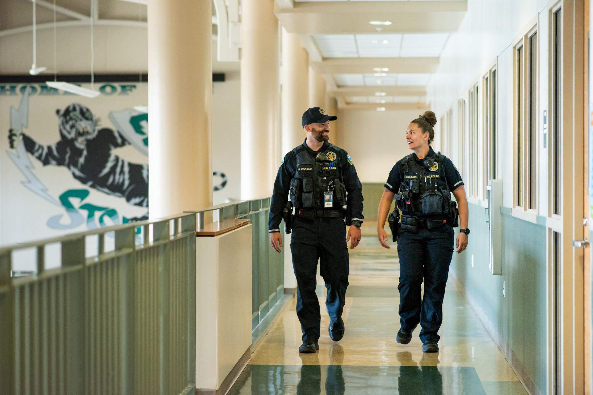 SROs walk through a school hallway