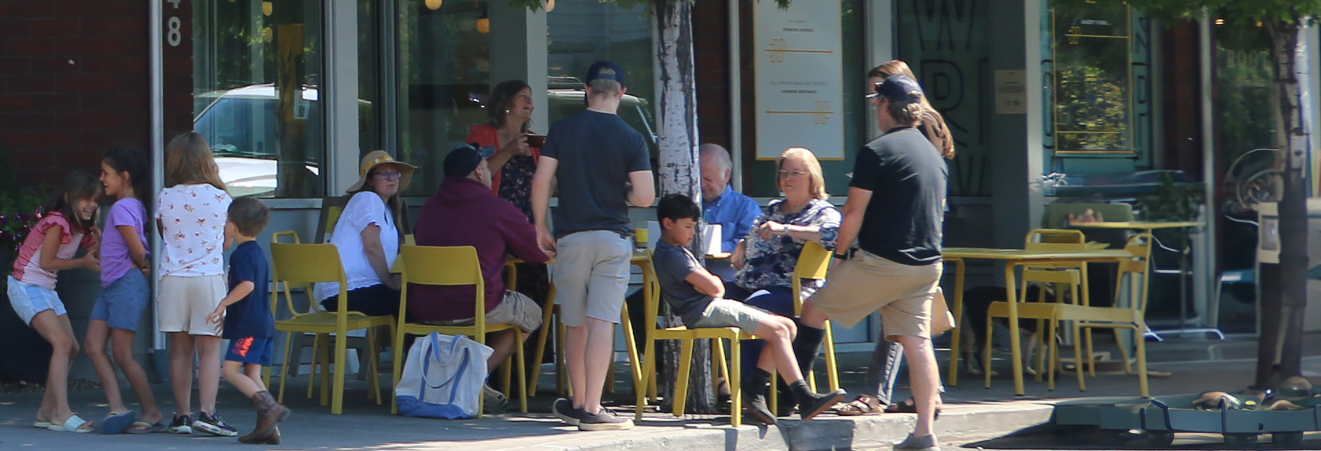 Diverse people enjoying food at a sidewalk cafe