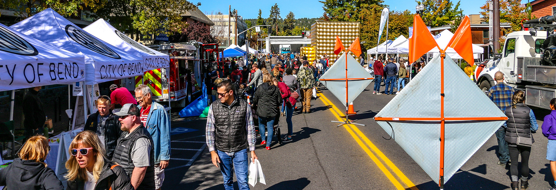 Downtown Bend city street holding an event filled with people