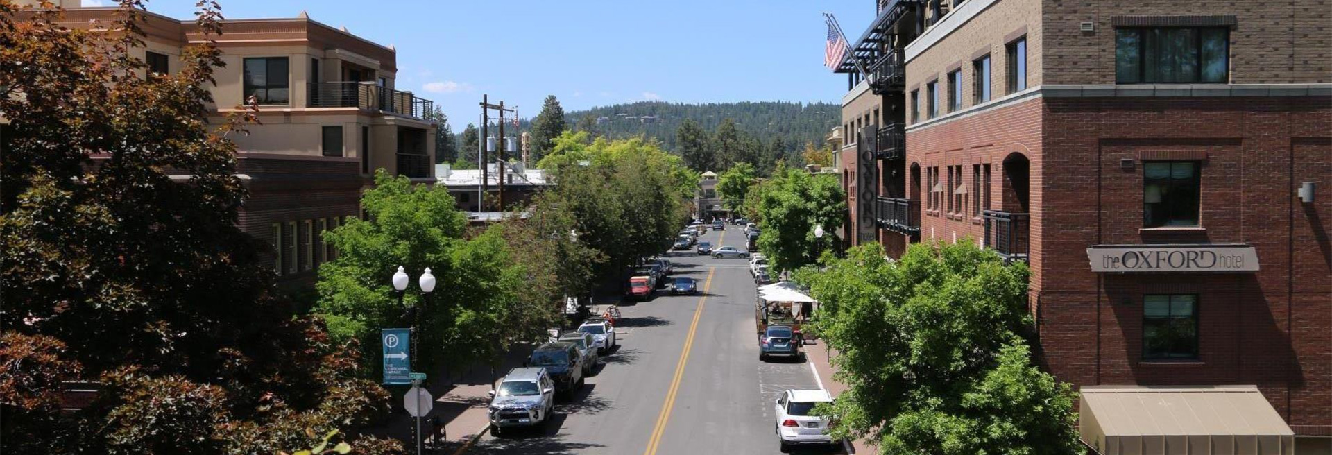 Downtown Bend looking West. Oxford hotel in the foreground, buildings on either side of Minnesota street.