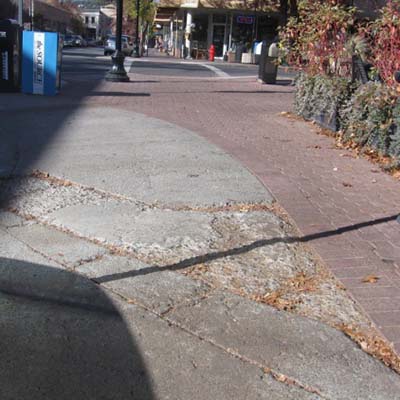 Sidewalk with surface deterioration.