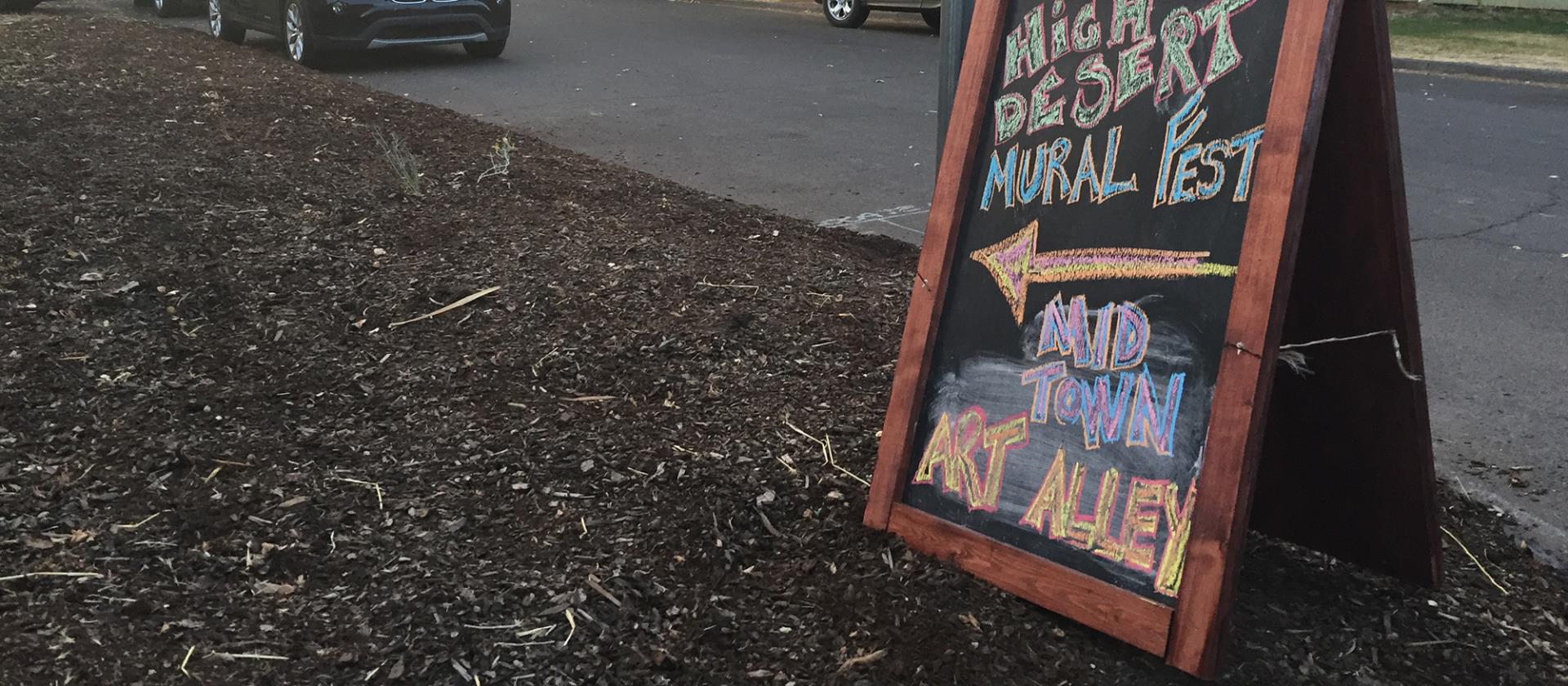 Chalkboard sign announcing event.