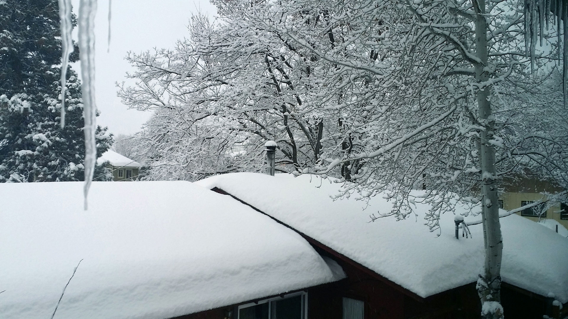 Rooftop covered in a foot and a half of snow.