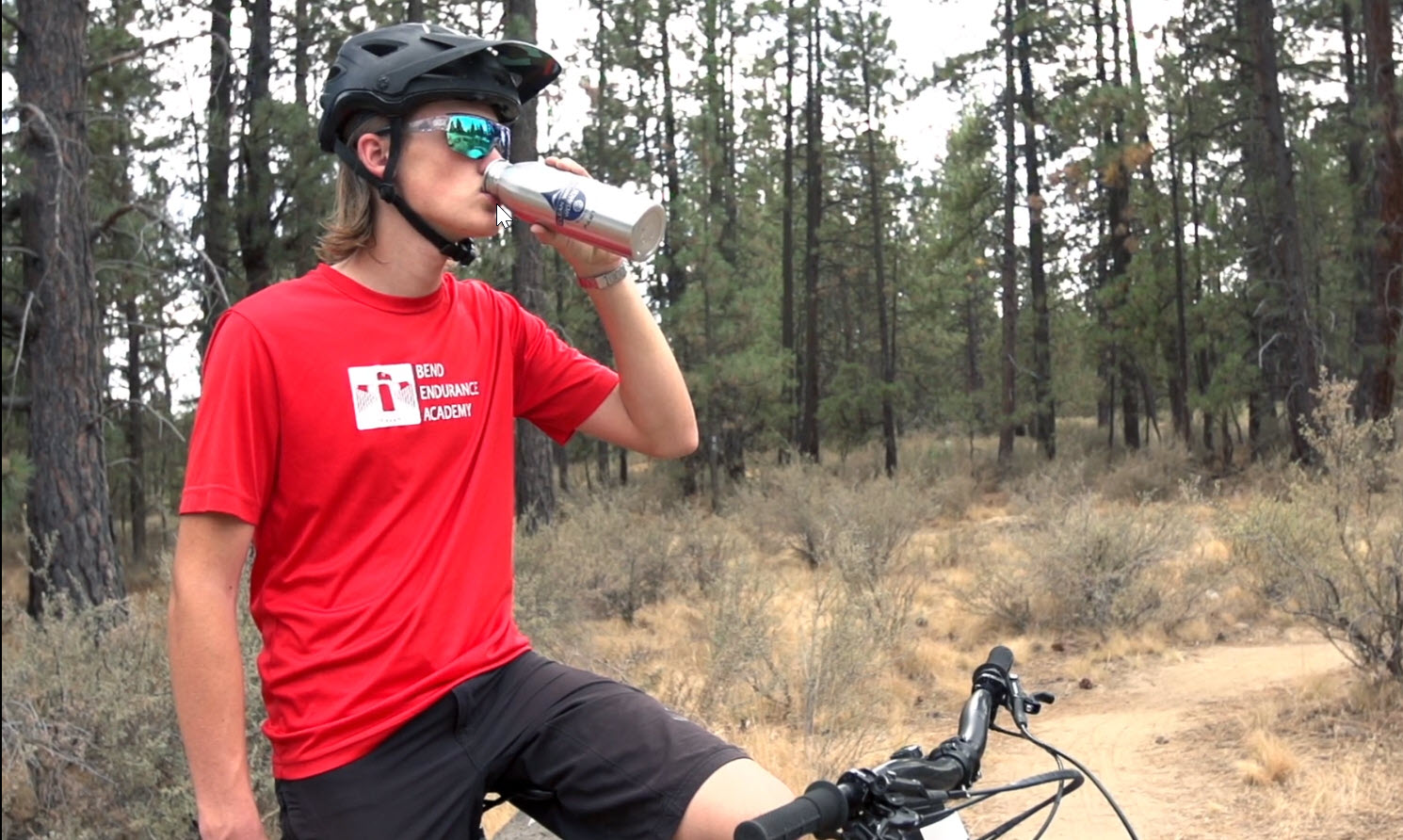 Bicyclist drinking water from water bottle