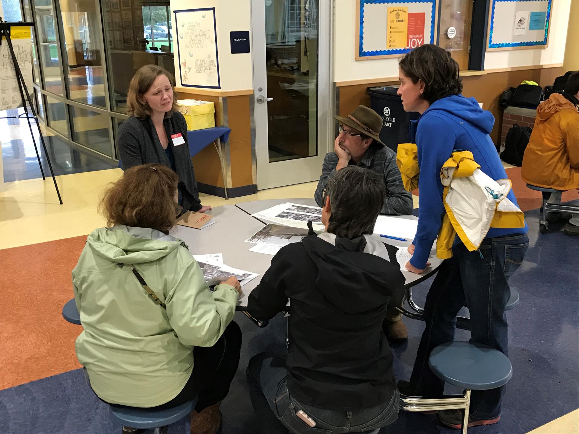 Photo of consultant speaking with community members at open house meeting