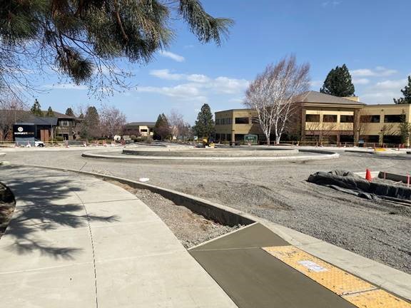 A photo of the Columbia/Colorado Roundabout project site with sidewalks, medians, curbs, and curb ramps.