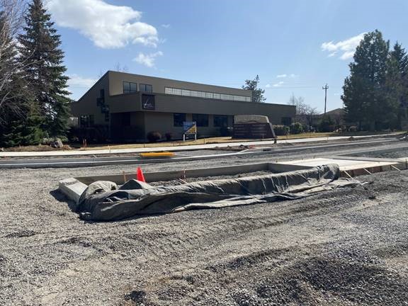 A photo of the Columbia/Colorado Roundabout project site with sidewalks, curbs, and a median.