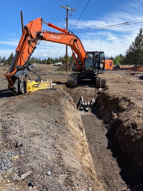 A photo of work crews and excavation equipment doing trench work at Deschutes Market Road near Monticello Estates.