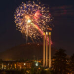Fireworks over Pilot Butte near the old mill three smokestacks.