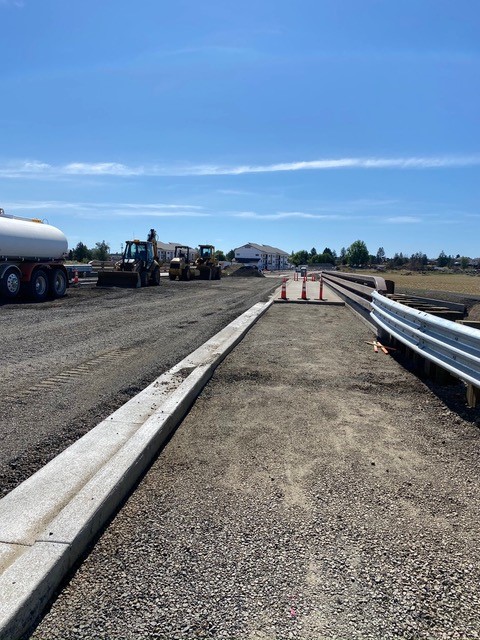 A photo of the path prepared and ready for a sidewalk to be poured over the Empire Avenue crossing structure.