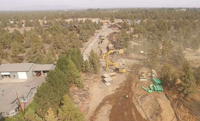 An aerial photo overlooking work crews and equipment worknig at the Pioneer Loop Crossing.