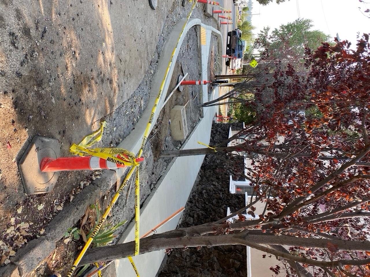 A photo of a new ADA ramp on NW Riverside St. surrounded by caution tape and cones.