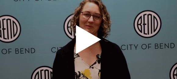 Bend City Mayor Melanie Kebler against a City of Bend backdrop with a play button overlay.