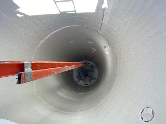A photo looking down into the newly installed 30-ft deep manhole.