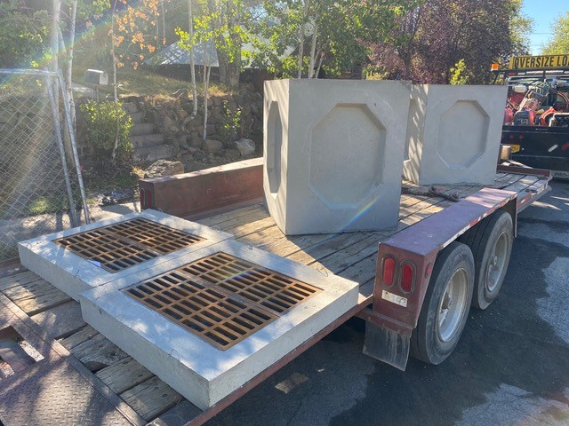 A photo of two stormwater catch basins on a trailer, ready to be installed.