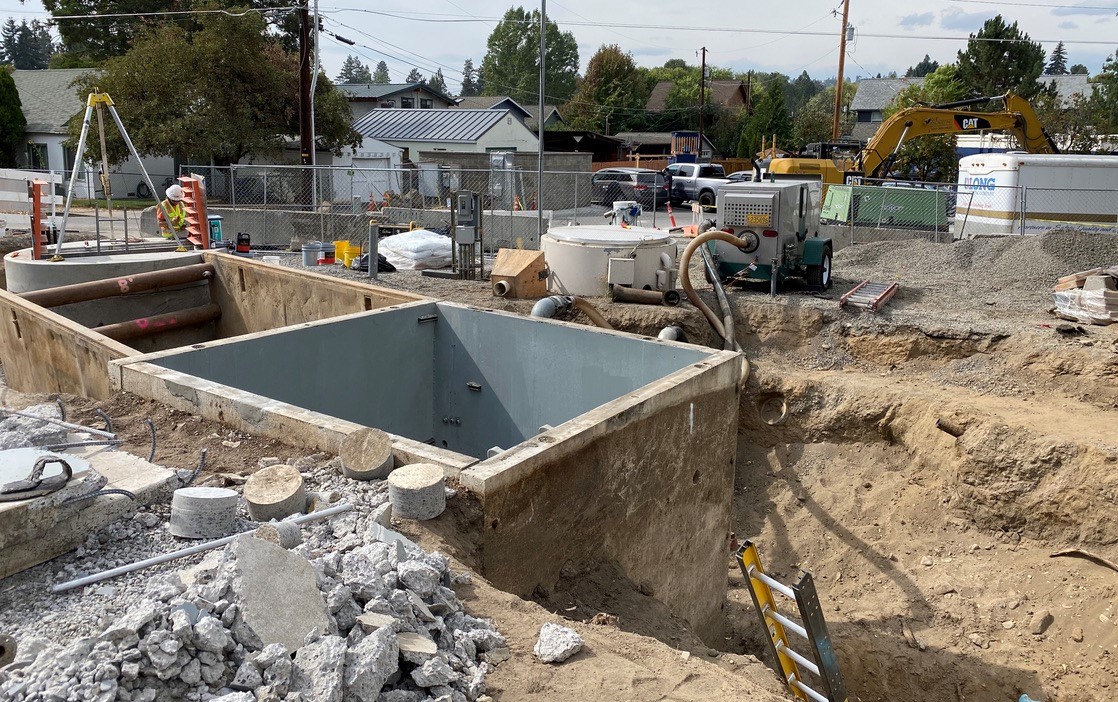 A photo of work crews and equipment continuing construction of the Drake pump station.