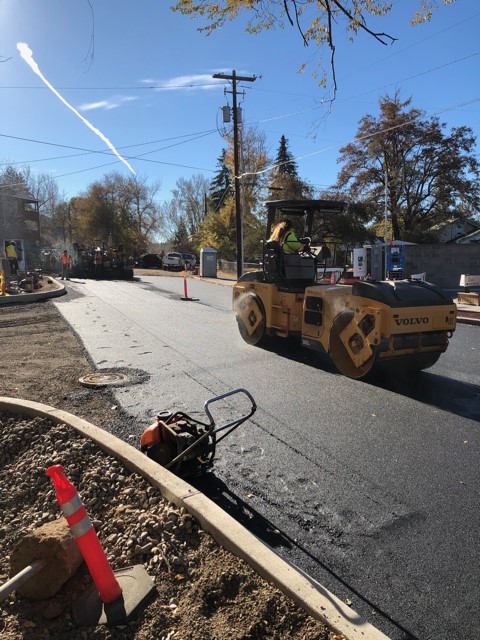 A photo of work crews and equipment doing asphalt paving on Riverside Blvd.
