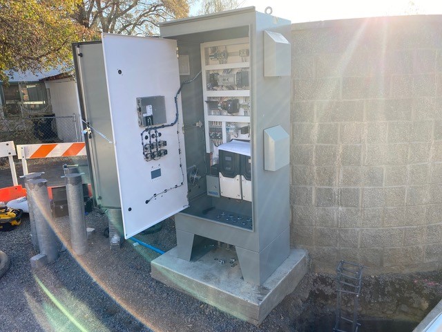 A photo of the opened control cabinet that contains all the programming to operate the new pump station.