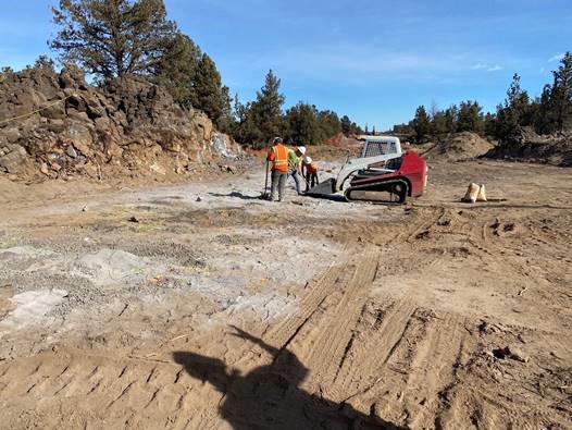 A photo of work crews and a compact track loader preparing for blasting of the COID trenchless crossing.