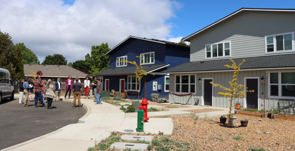 City of Bend councilors talking in front of houses.