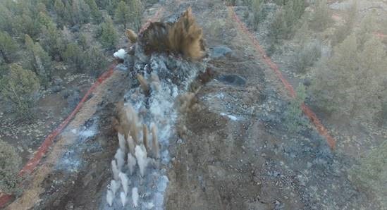 An aerial photo of blasting work taking place at Juniper Ridge.
