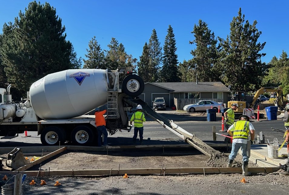 concrete truck and crew preparing driveway