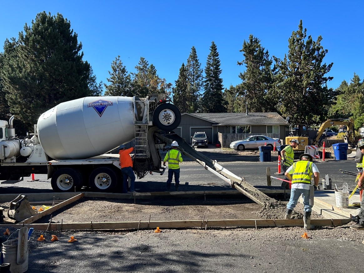 Crews pouring driveways as part of the modernization work