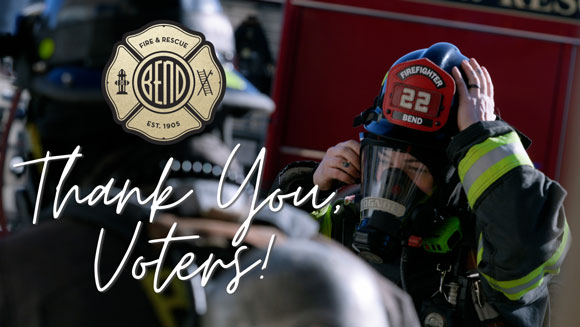 Firefighters gearing up with their helmets and masks with a thank you tagline over the image