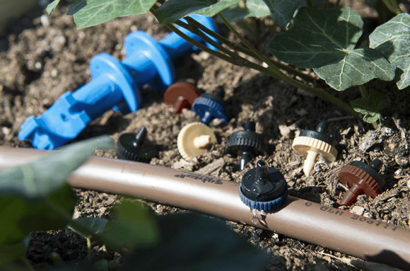 A water hose with garden nibs on it.