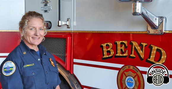 Deputy Chief Trish Connolly standing in front of a fire engine