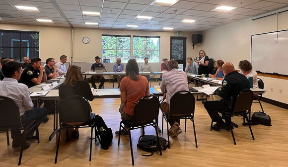 City officials and community members sitting around tables
