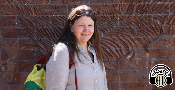 A picture of Carrie Karl standing in front of a brick wall