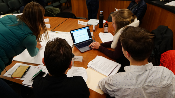 People working at a table with papers