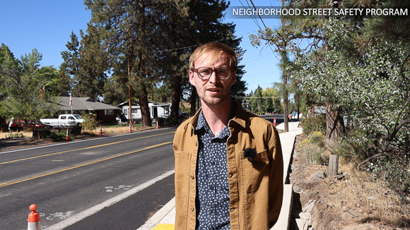 Man standing in front of a street that is under construction