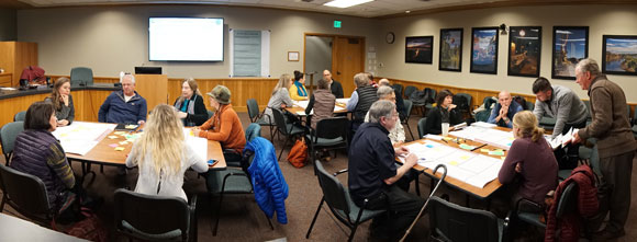 Groups of people at tables meeting together