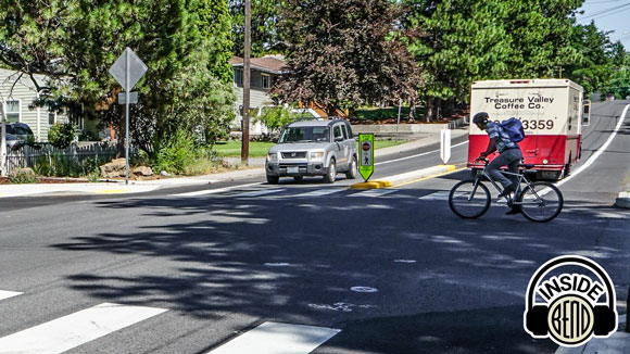 Image of man crossing intersection on a bicycle