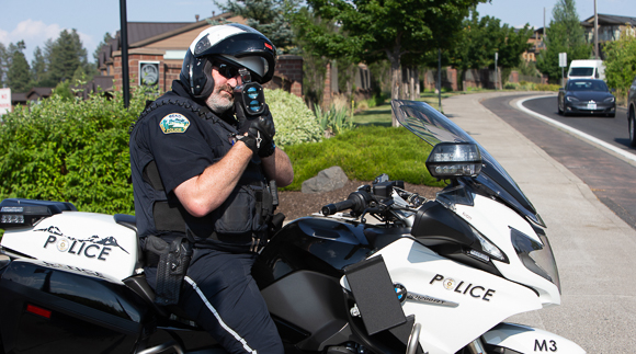 Police officer with radar gun on motorcycle