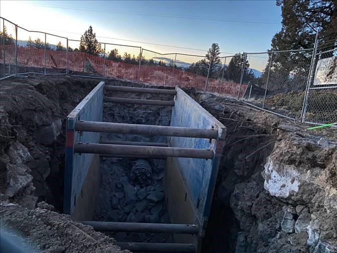 A photo of the BNSF receiving shaft excavation site surrounded by a fence barricade.
