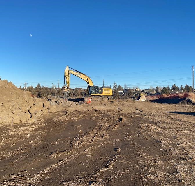 A photo of work crews using large excavation equipment at the OR 97 Crossing receiving shaft.